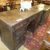 A C20th oak desk the plank top above car