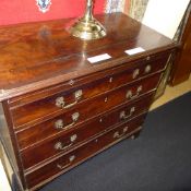 A Georgian mahogany bachelors chest with brush slide four graduated drawers bracket feet