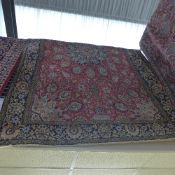 An extremely fine central Persian part silk Qum rug the central floral medallion on a rouge field