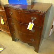 An early C20th walnut chest having three graduated drawers on bracket feet