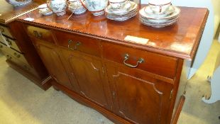 A yewood side cabinet with drawers above cupboards