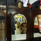 An antique walnut hall mirror the arched