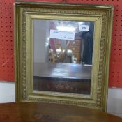 A small C19th giltwood oak mirror the rectangular plate within a moulded and leaf decorated frame
