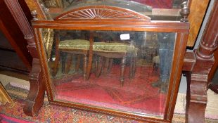 An Edwardian mahogany mirror the carved