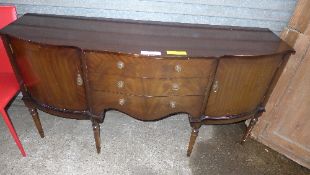 A C20th mahogany serpentine sideboard wi