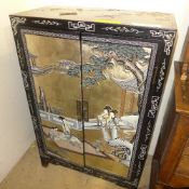 A black lacquered cabinet Geisha decoration on two panel doors