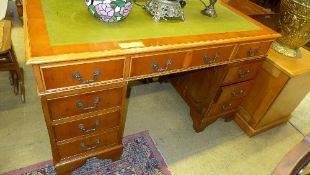 A yewood pedestal desk the tooled leather top above drawers