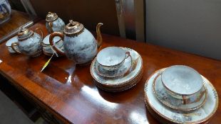 A Japanese egg shell tea service comprising teapot, jug bowl cups and saucers
