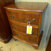 A yewood bowfront chest having three dra
