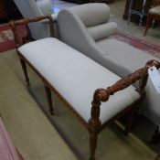A mahogany window seat with ivory damask