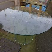 A circular glass modernist dining table
