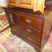 A late Victorian walnut chest having two short above two long drawers