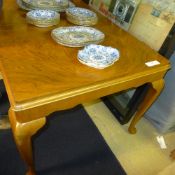 A mid C20th walnut extending dining tabl