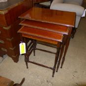 A nest of four mahogany tables the cross