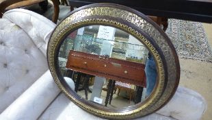 A wall mirror the oval plate in gilded f