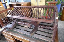 A Regency style mahogany cot, spindle sides and curtains pole