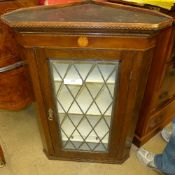 An antique oak and inlaid mahogany corne