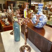 A pair of copper five branch candelabra