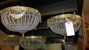 A pair of cut glass and brass ceiling lights