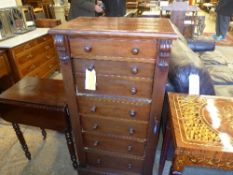 A Victorian mahogany Wellington chest having fitted secretaire drawer raised on plinth base