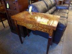 A profusely carved inlaid card table on tapered supports
