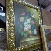 An oil on canvas still life of flowers in gilt frame