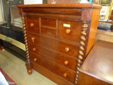 A Victorian mahogany Scottish chest having an arrangement of drawers on turned feet