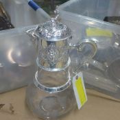 A large silver plated claret jug with grape decoration