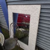 A cream painted embossed garden mirror