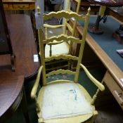 Two ochre painted ladder back open armchairs with ladder backs on stretchered supports
