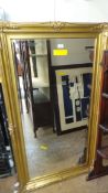 A gilded wall mirror the bevelled plate