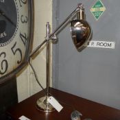 A chrome adjustable desk lamp