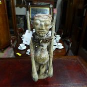 A large carved African figure with cowri