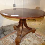 A C19th continental mahogany occasional table the circular top on down swept supports united by