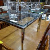 A pair of low tables the glass tops rais