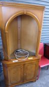 A C20th walnut corner cupboard with open shelves above panel doors