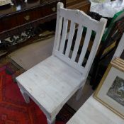 A pair of white painted teak slatted bac