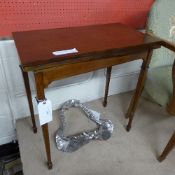 An Edwardian mahogany inlaid card table the satinwood banded foldover top revealing baize interior
