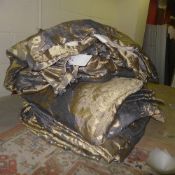 A pair of double lined gilt curtains and