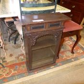 A mahogany piano seat and a glazed displ