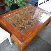 A Chinese lacquered low table with glass