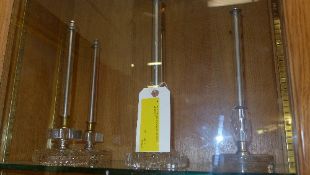 A set of three pairs of glass and metal stick candlesticks