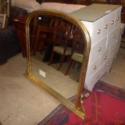 A gilt arched overmantle mirror