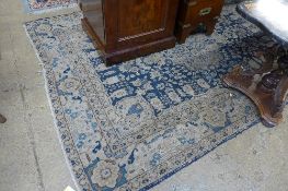A hand knotted Persian rug the blue ground with floral pendant within multi border