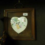 A pair of heart shaped erotic plaques
