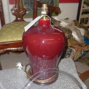 A pair of bulbous maroon table lamps