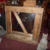 A rustic pine framed wall mirror with shelf