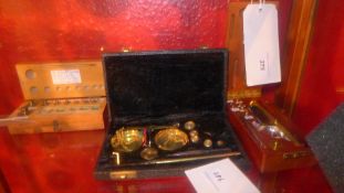 Two set of jewellers weighing scales in wooden cases and a set of weights