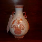 A Chinese twin handled vase glazed white and orange