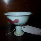 A Chinese porcelain stem cup with red detail and six character marks to the base